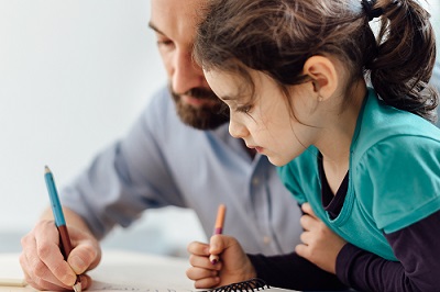 Man and child writing