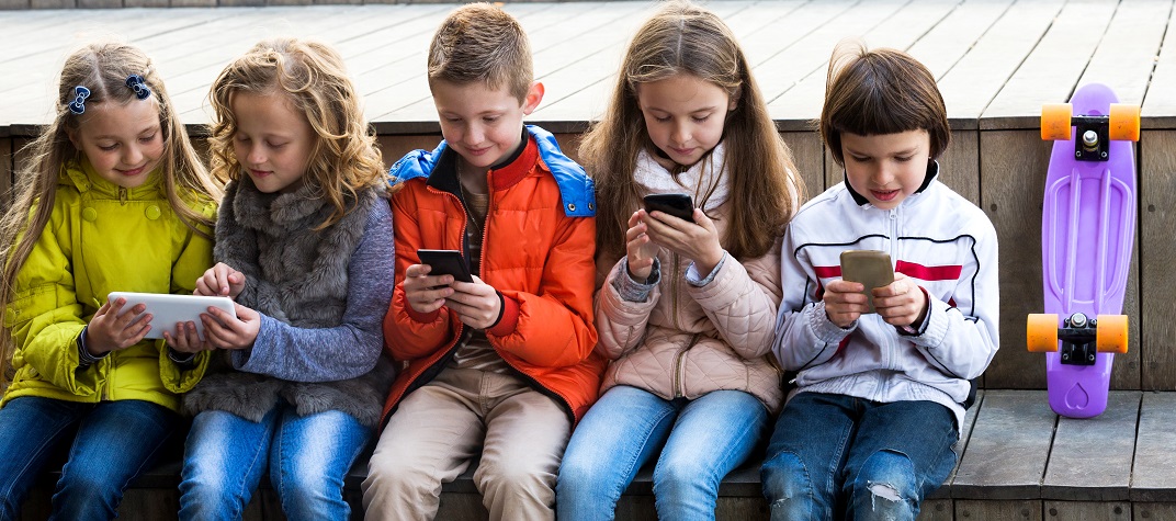 Row of children sitting on a bench