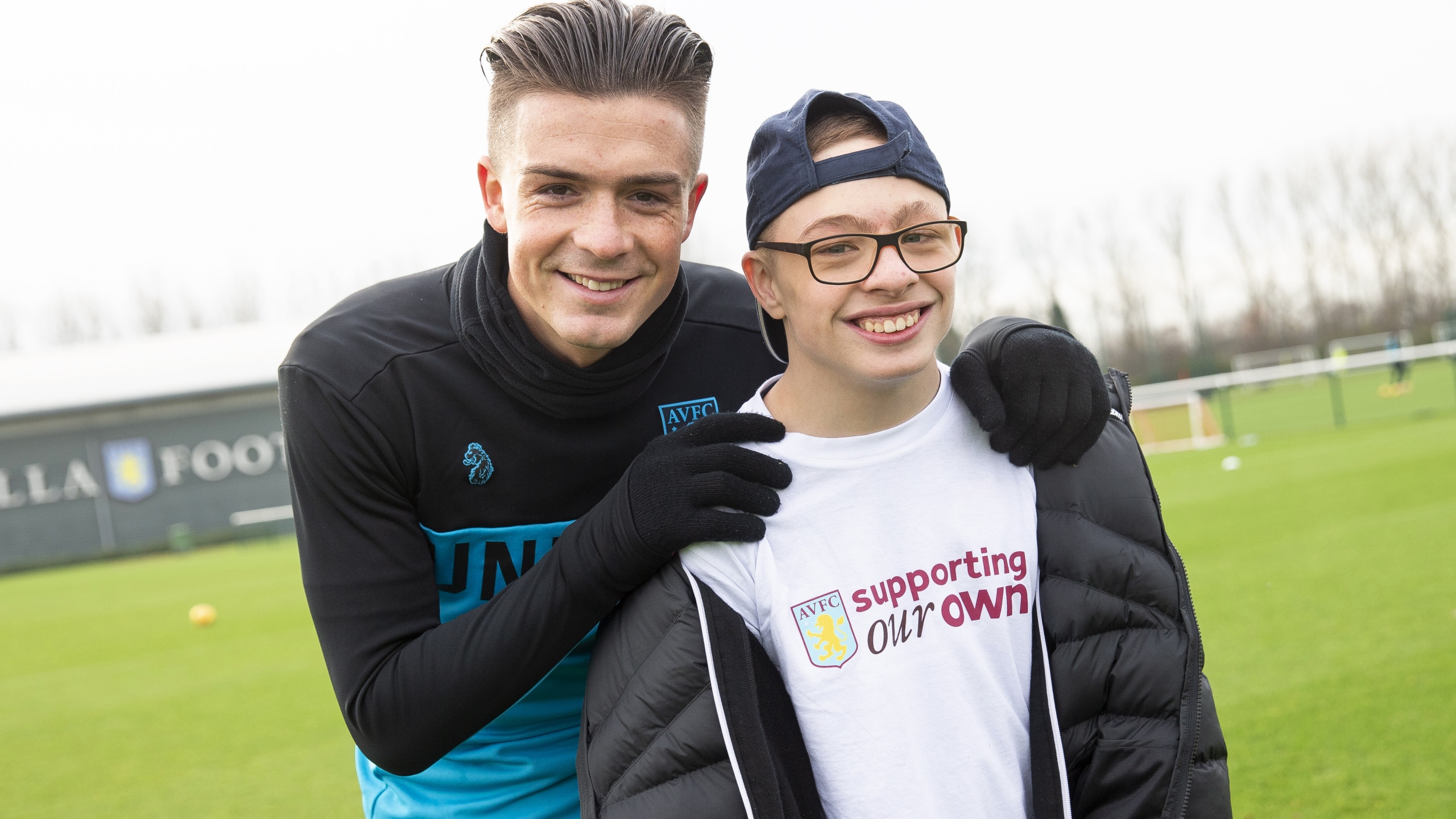 Jack Grealish smiles for a photo with a young person from Birmingham Children's Trust