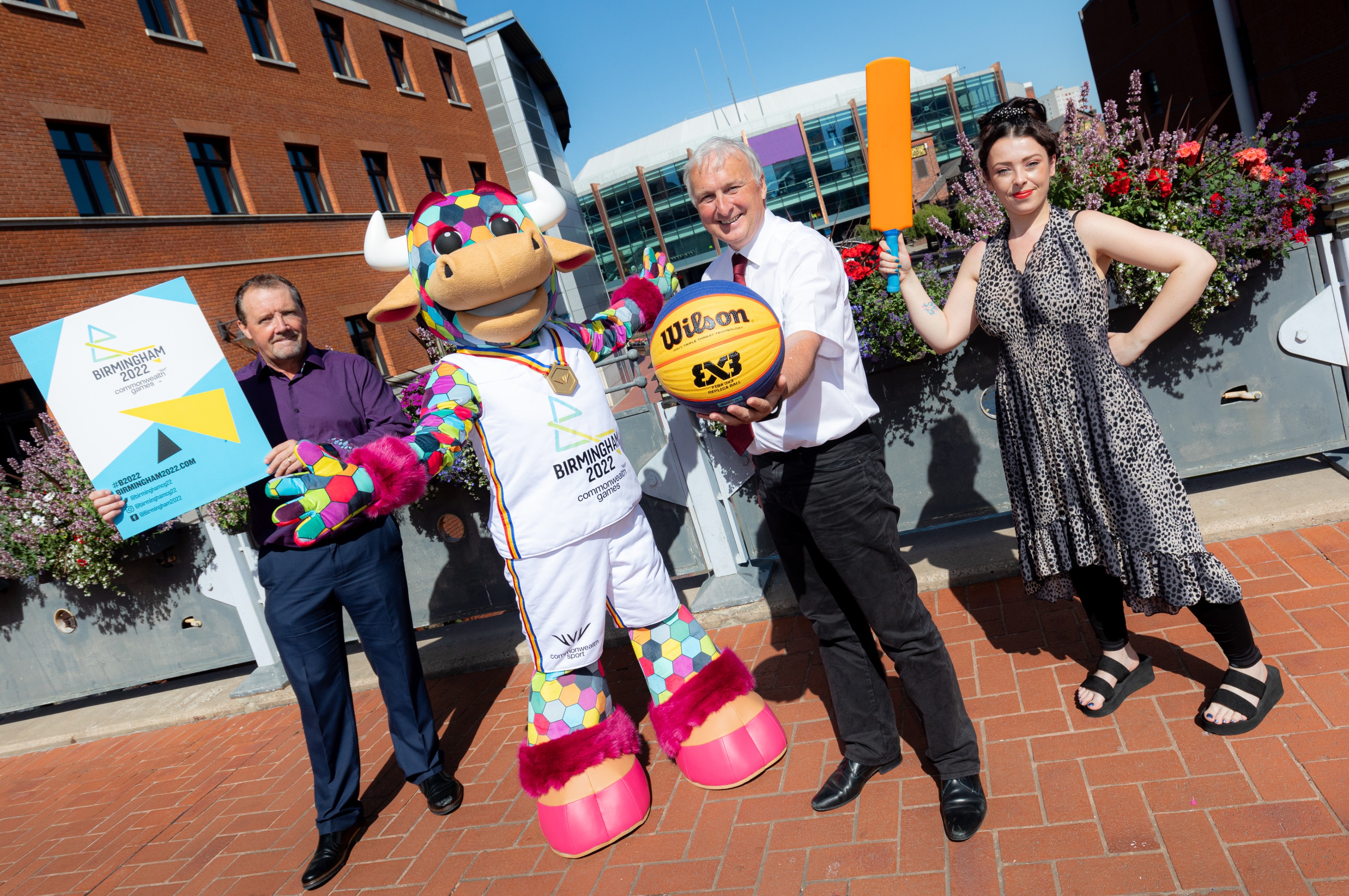 Representatives of the Birmingham Commonwealth Games 2022, Birmingham Children's Trust and Birmingham City Council stand with the games mascot Perry the bull.